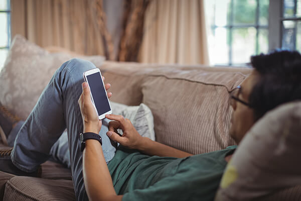 using smartphone on couch